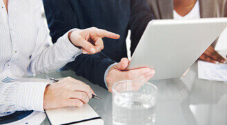 Business team collaborating around tablet